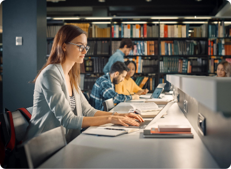 Woman using computer in library